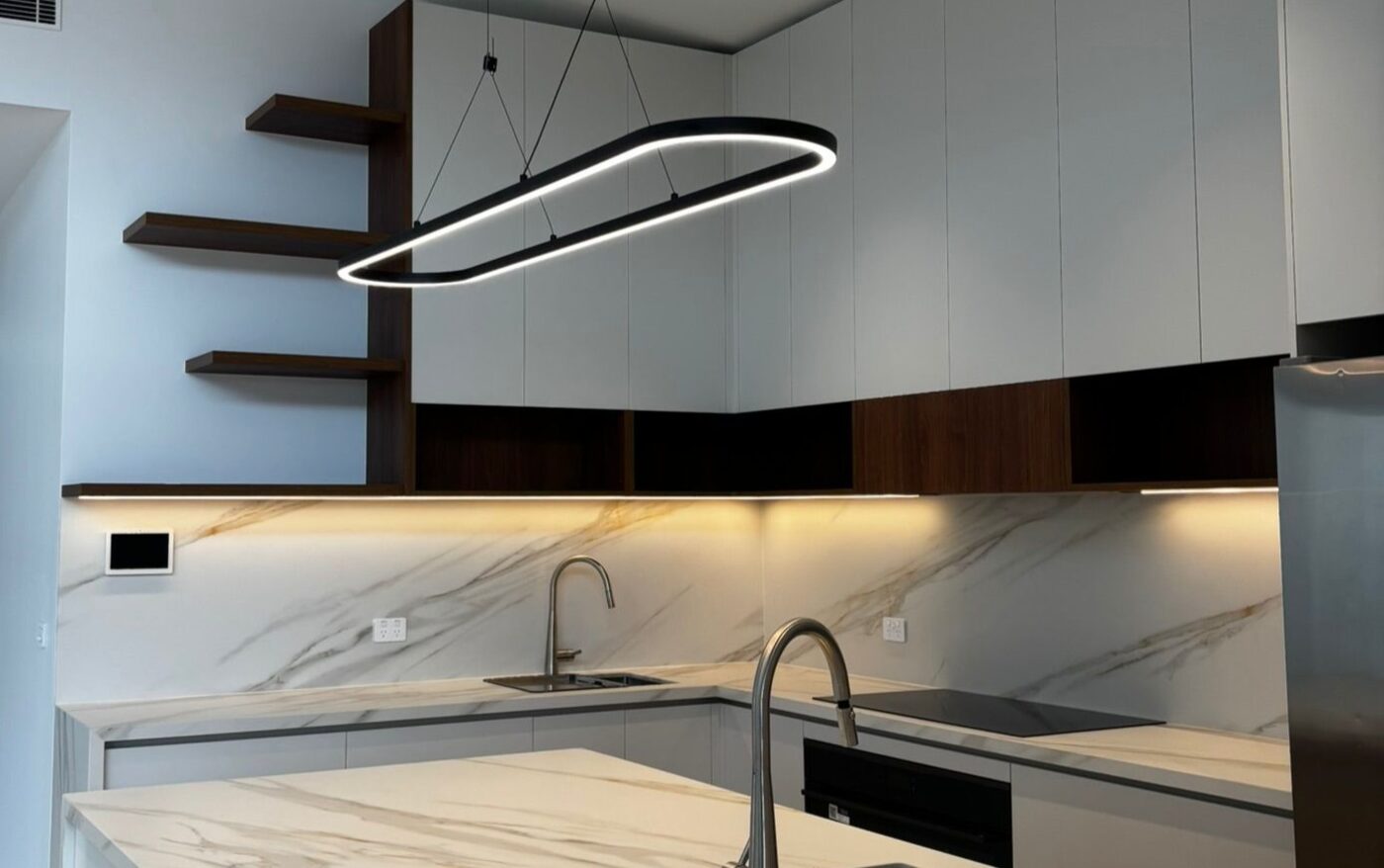 Kitchen with linear pendant and under bench strip lighting
