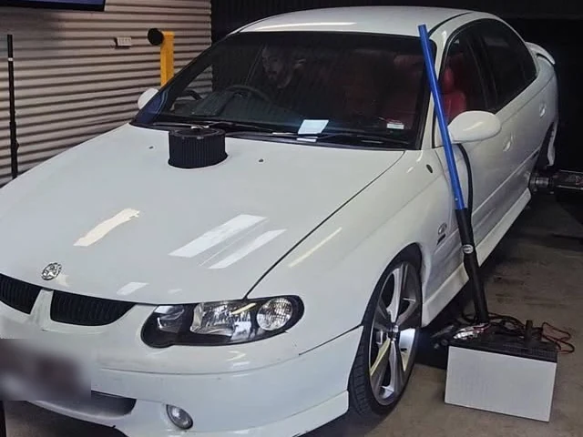 A white Commodore SS in the workshop