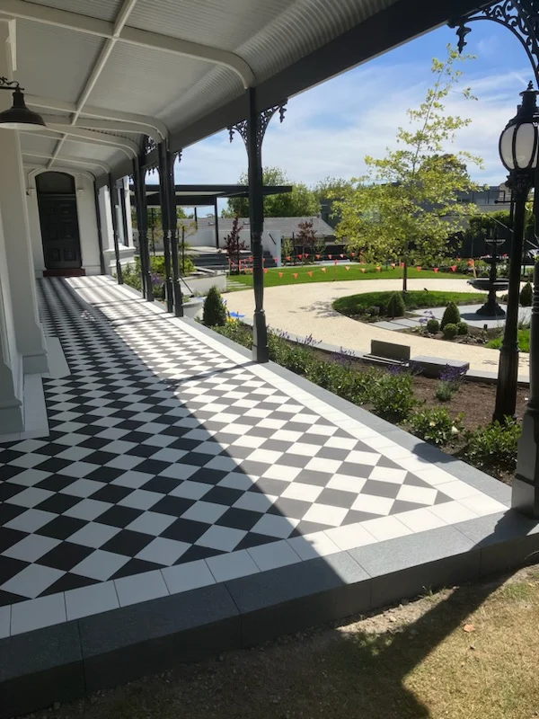 Black and white chequerboard verandah tiled by R.E.M Tiling