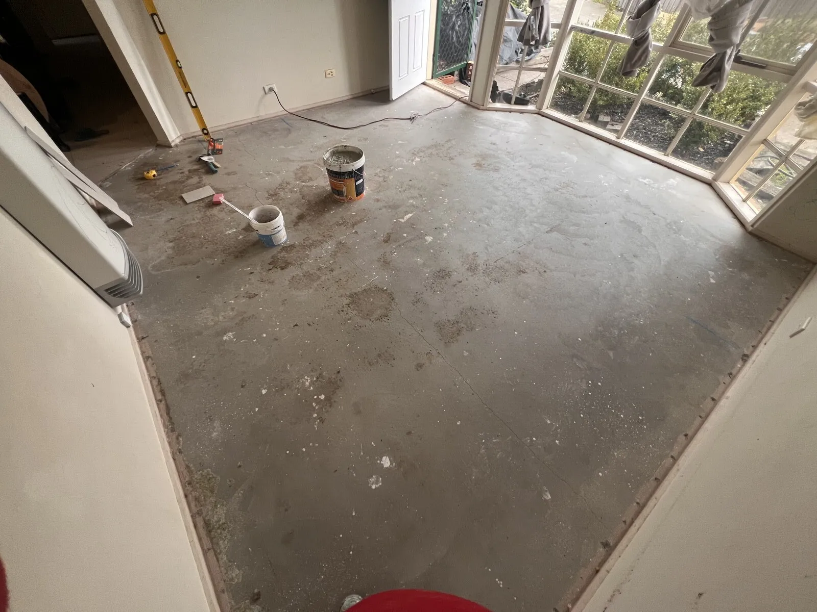 A bare concrete floor in a Melbourne home before tiling