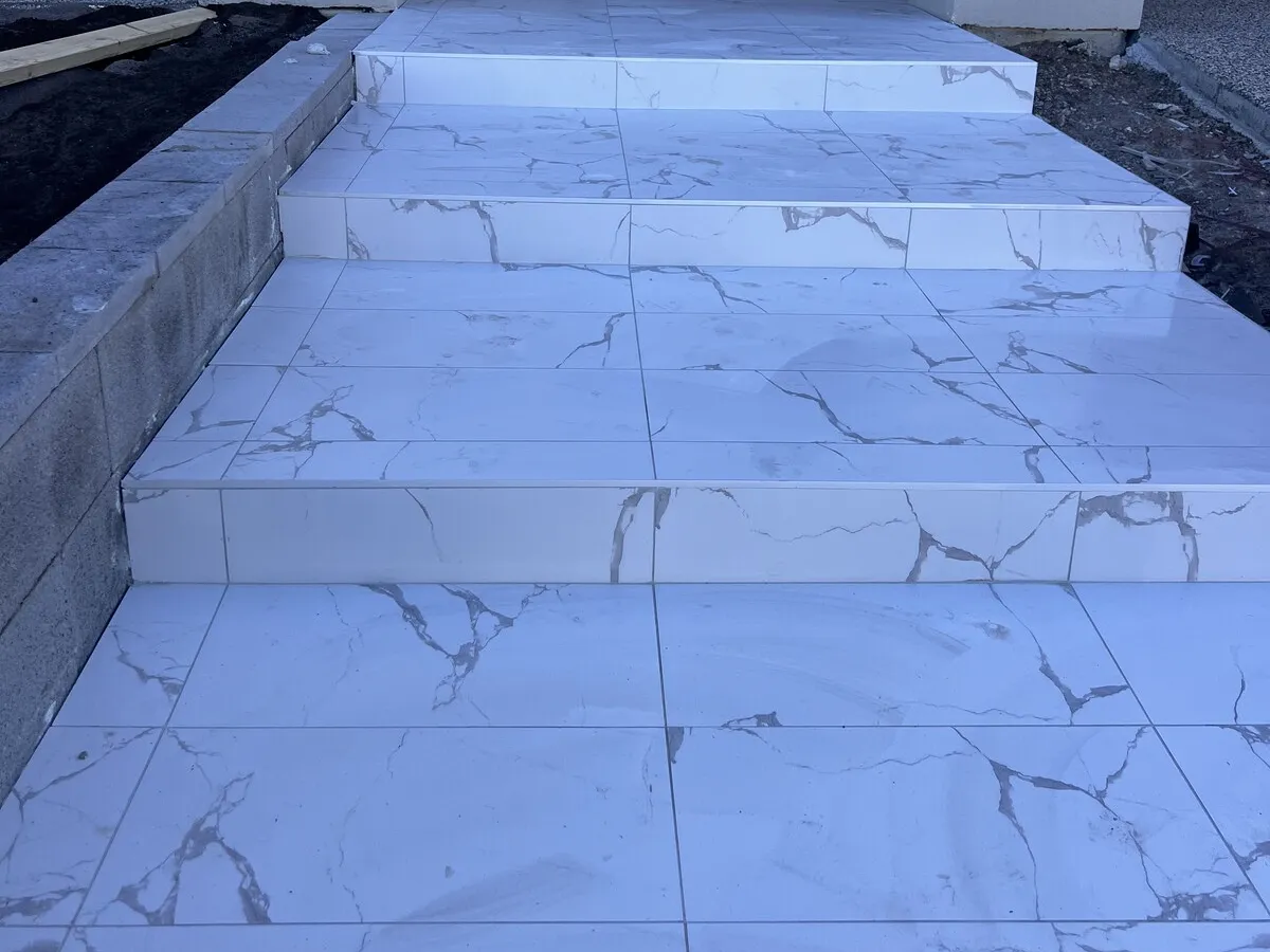 Marble look porcelain tiles on a set of front steps
