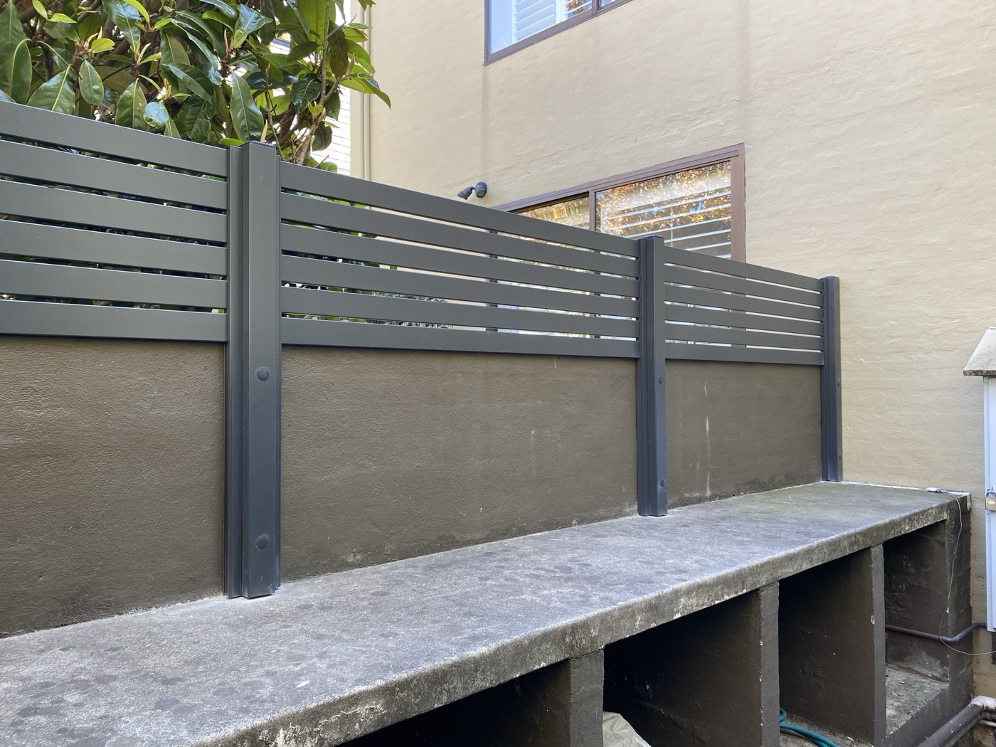 Dark slat fence panels built by JT Handyman in South Yarra