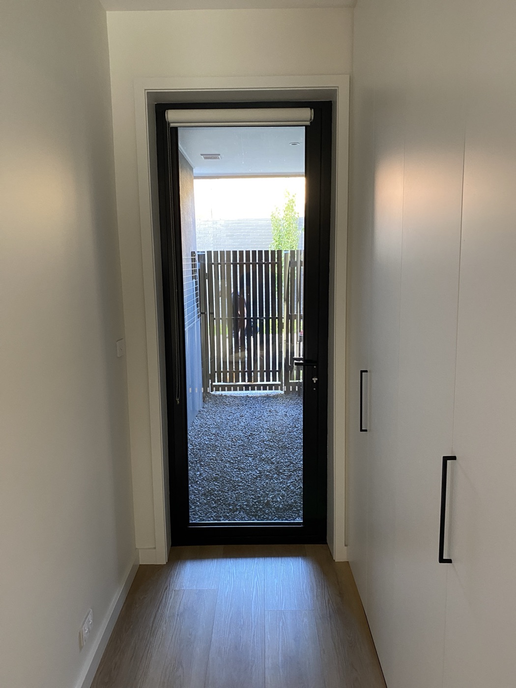 Hallway and glass courtyard door by JT in Melbourne