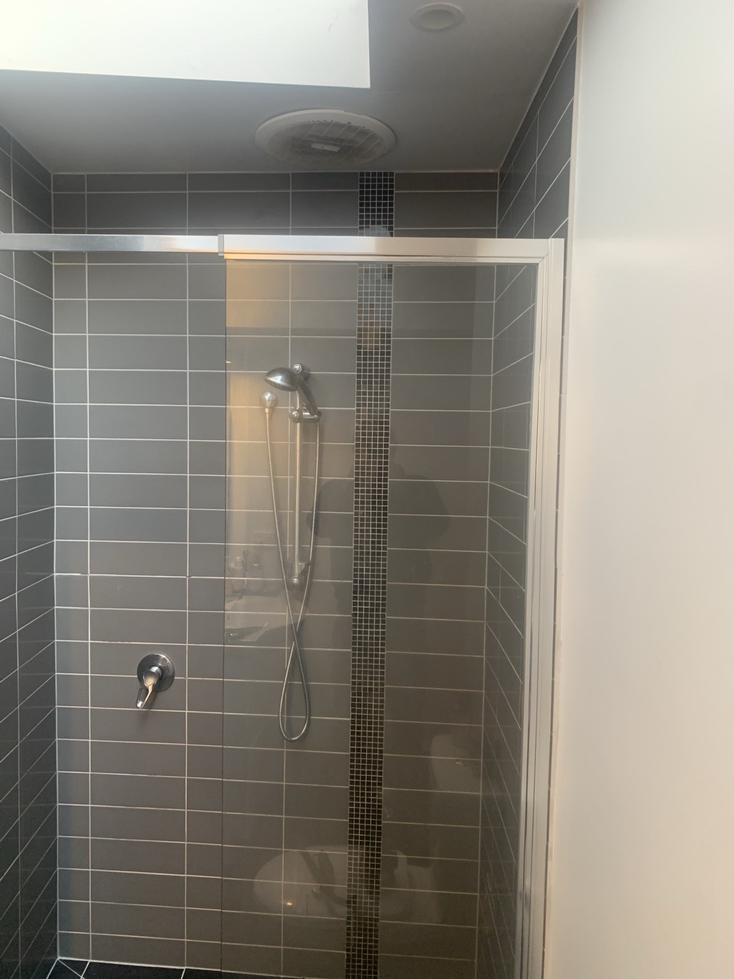 Feature-strip shower tiling by JT in North Melbourne