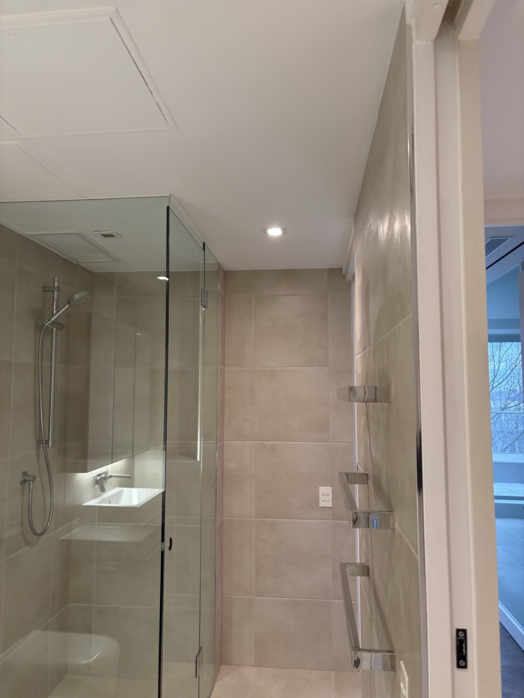 Tiled shower with glass screen by JT in East Melbourne