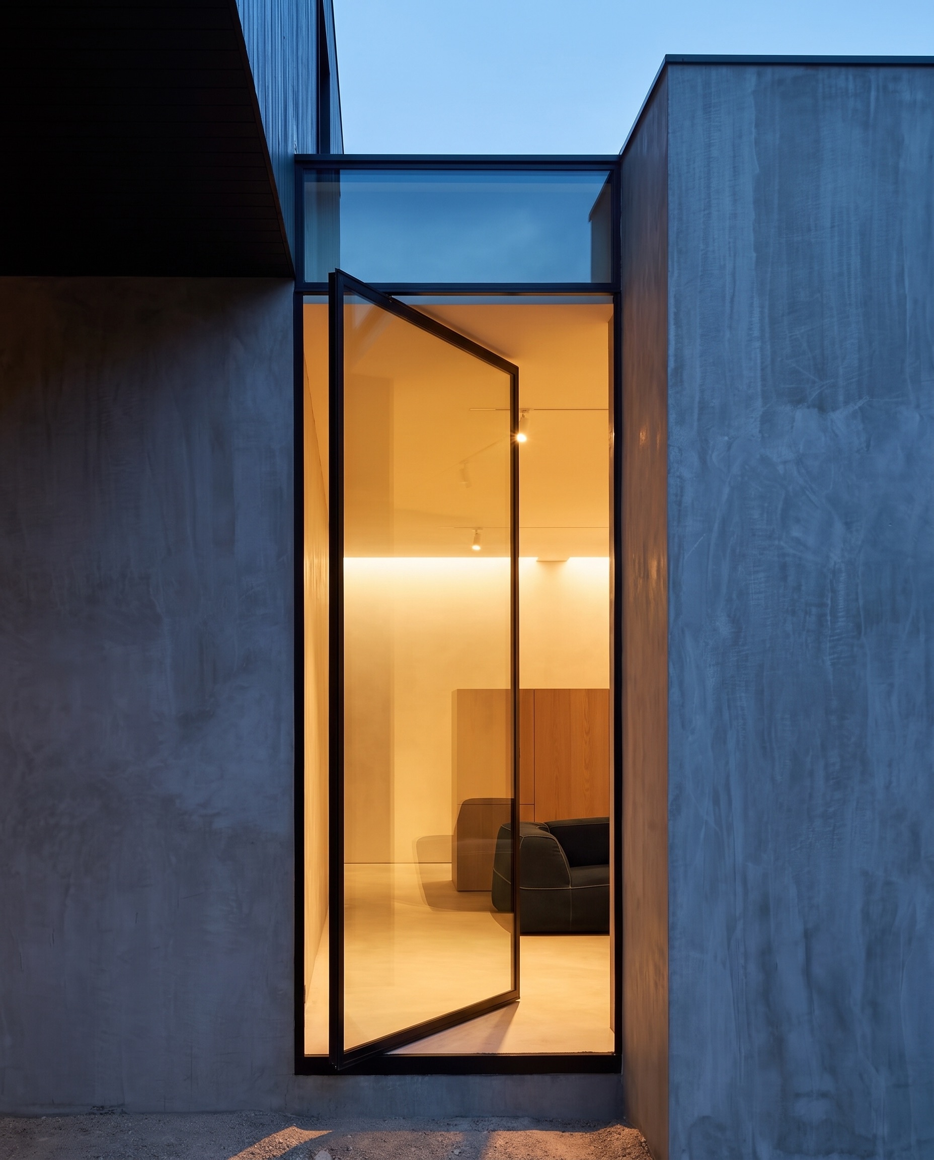 Kooyong. The glass entrance at dusk.