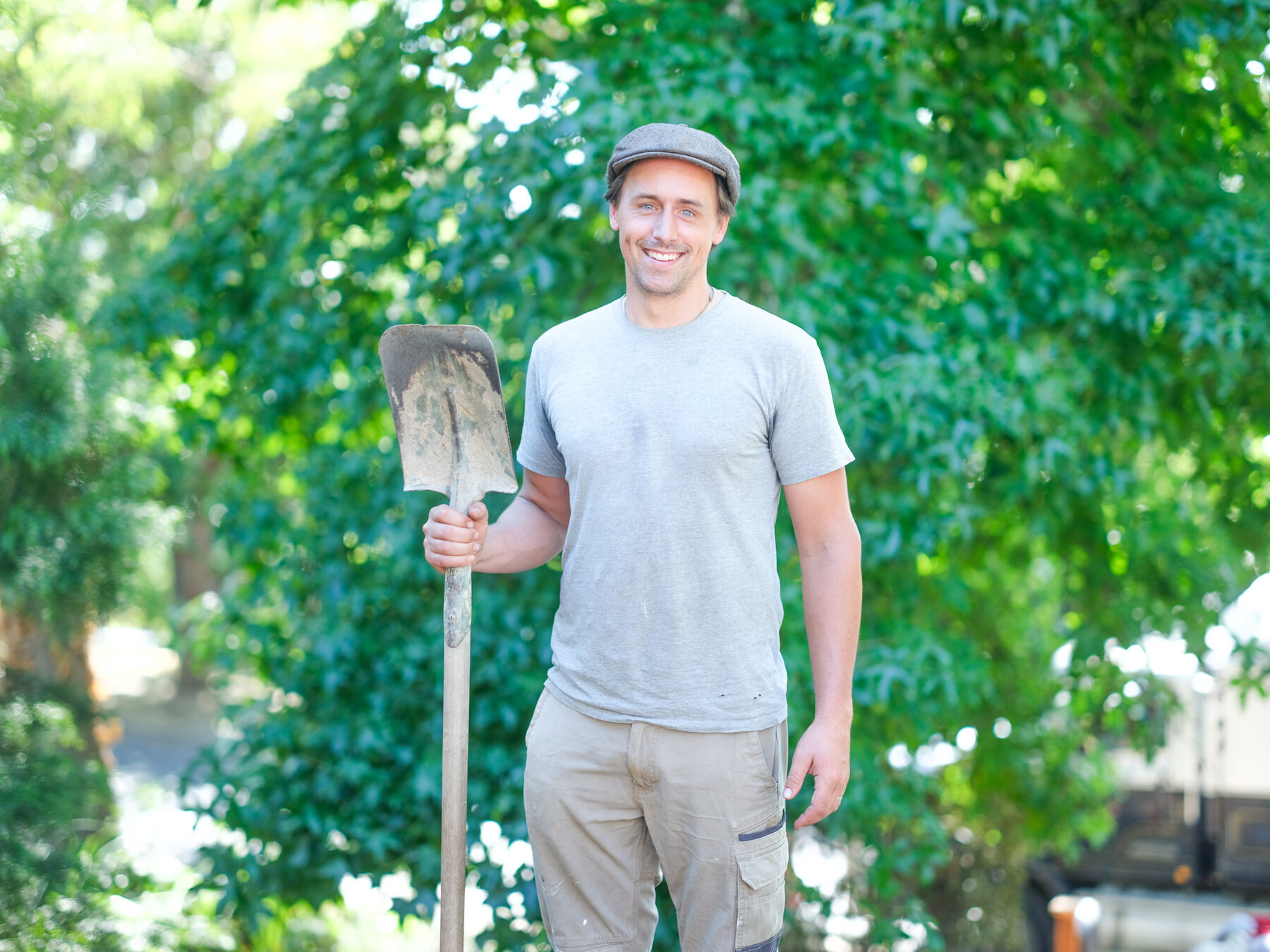Ollie Macindoe holding a shovel and smiling