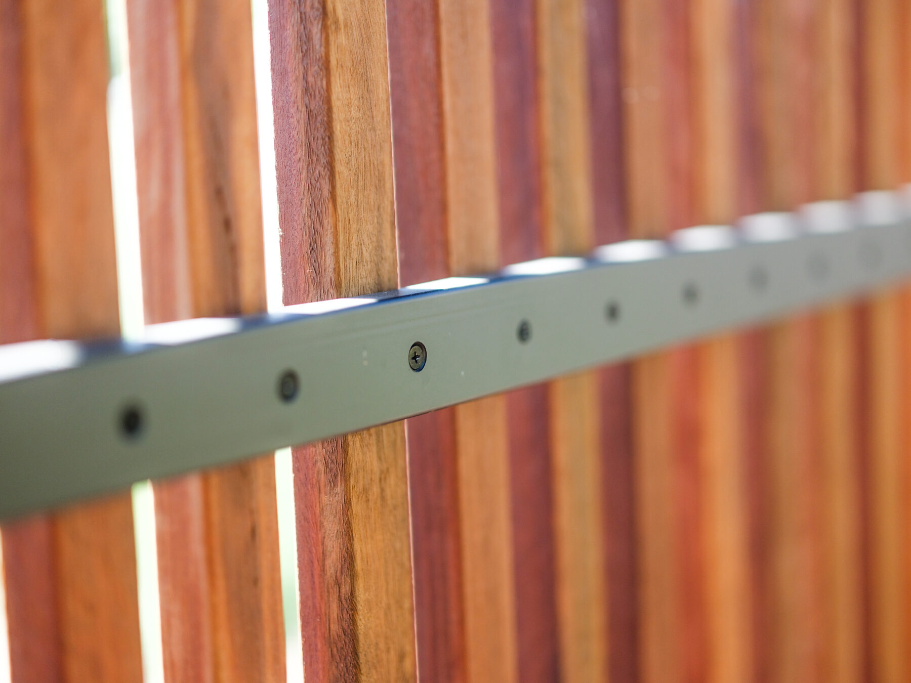 Steel rail fixed to hardwood slats with countersunk screws