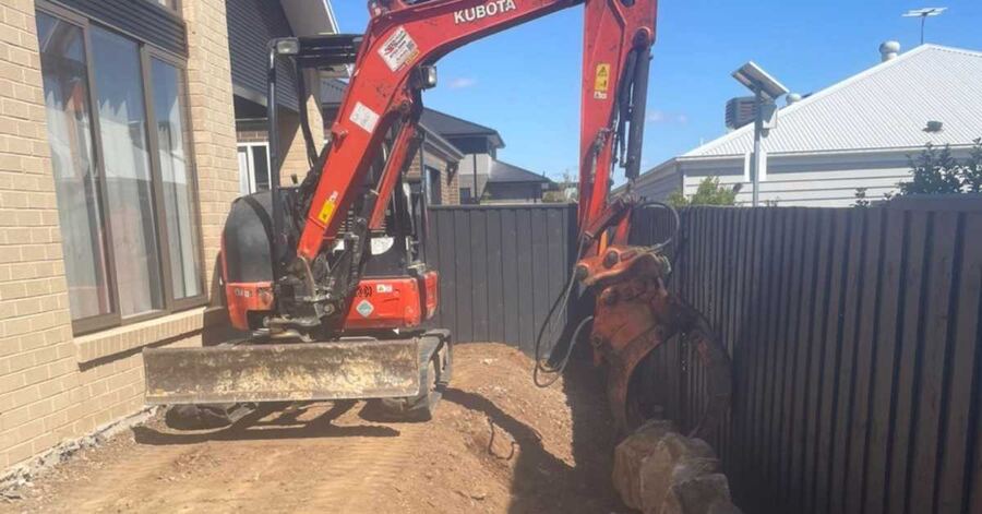 Excavator placing large rocks