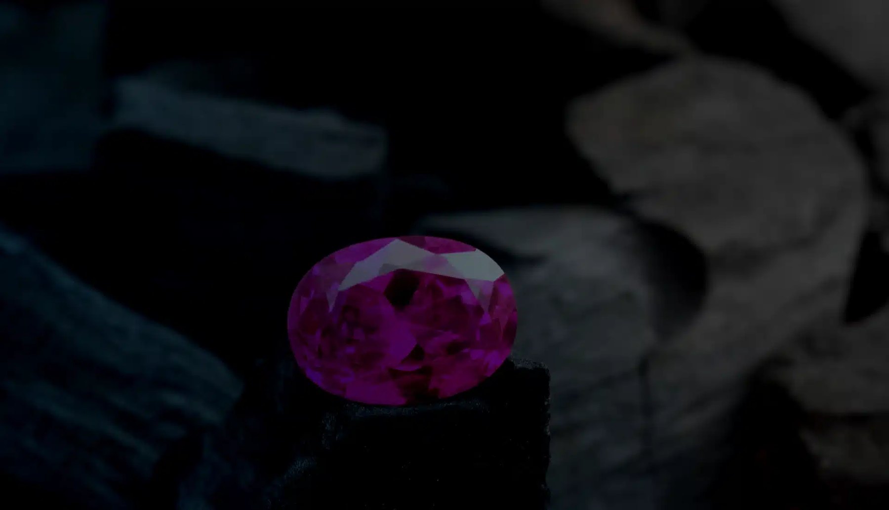 A pink sapphire photographed under low light