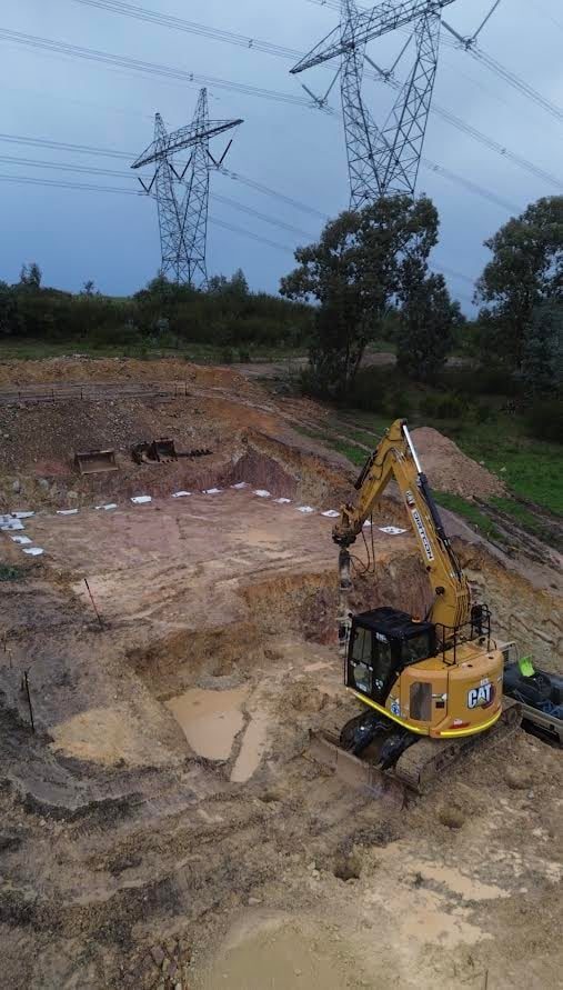 Excavation under high voltage transmission lines, where the exclusion zone sets the method.