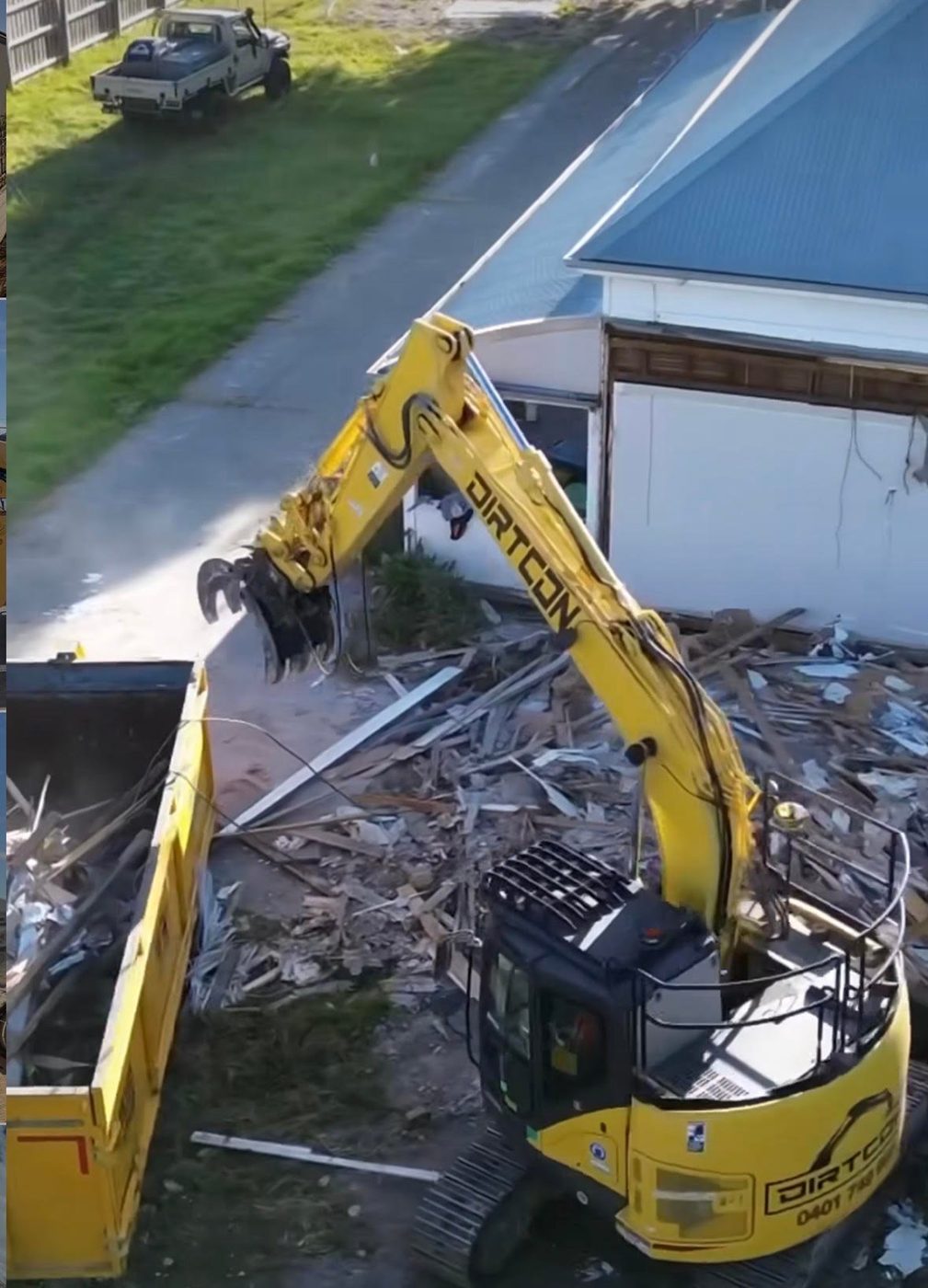 A Dirtcon machine breaking down a structure and sorting the material as it goes.