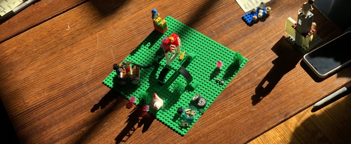 A table of LEGO Serious Play models mid workshop