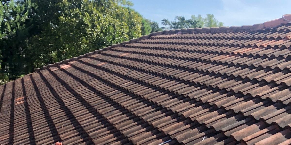 A Melbourne terracotta tile roof before restoration, weathered and covered in grime