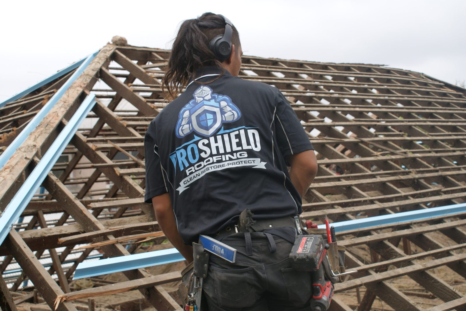 A Pro Shield roofer on a stripped roof frame with new battens installed