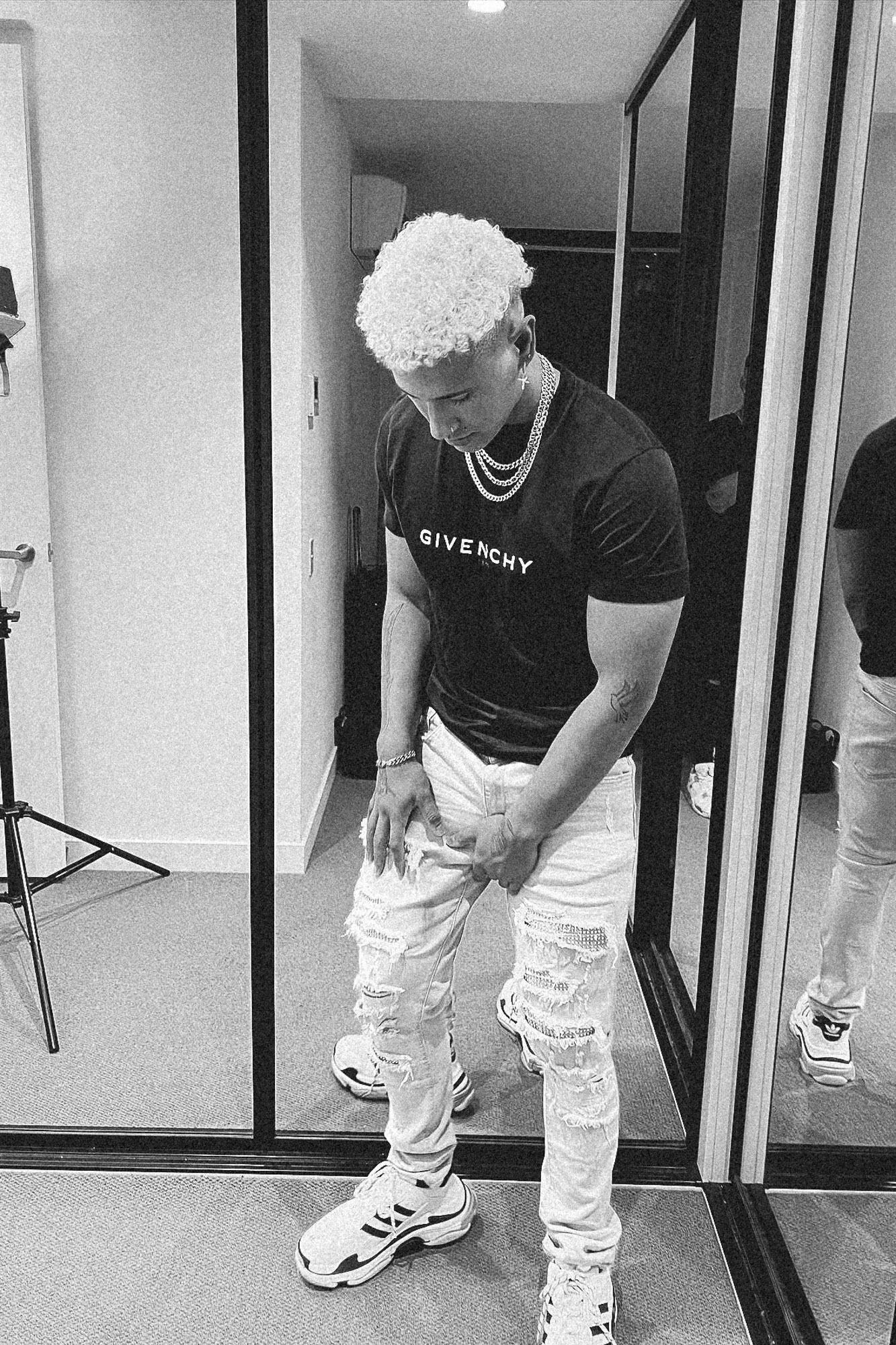 Black and white portrait in a white outfit, mirror shot