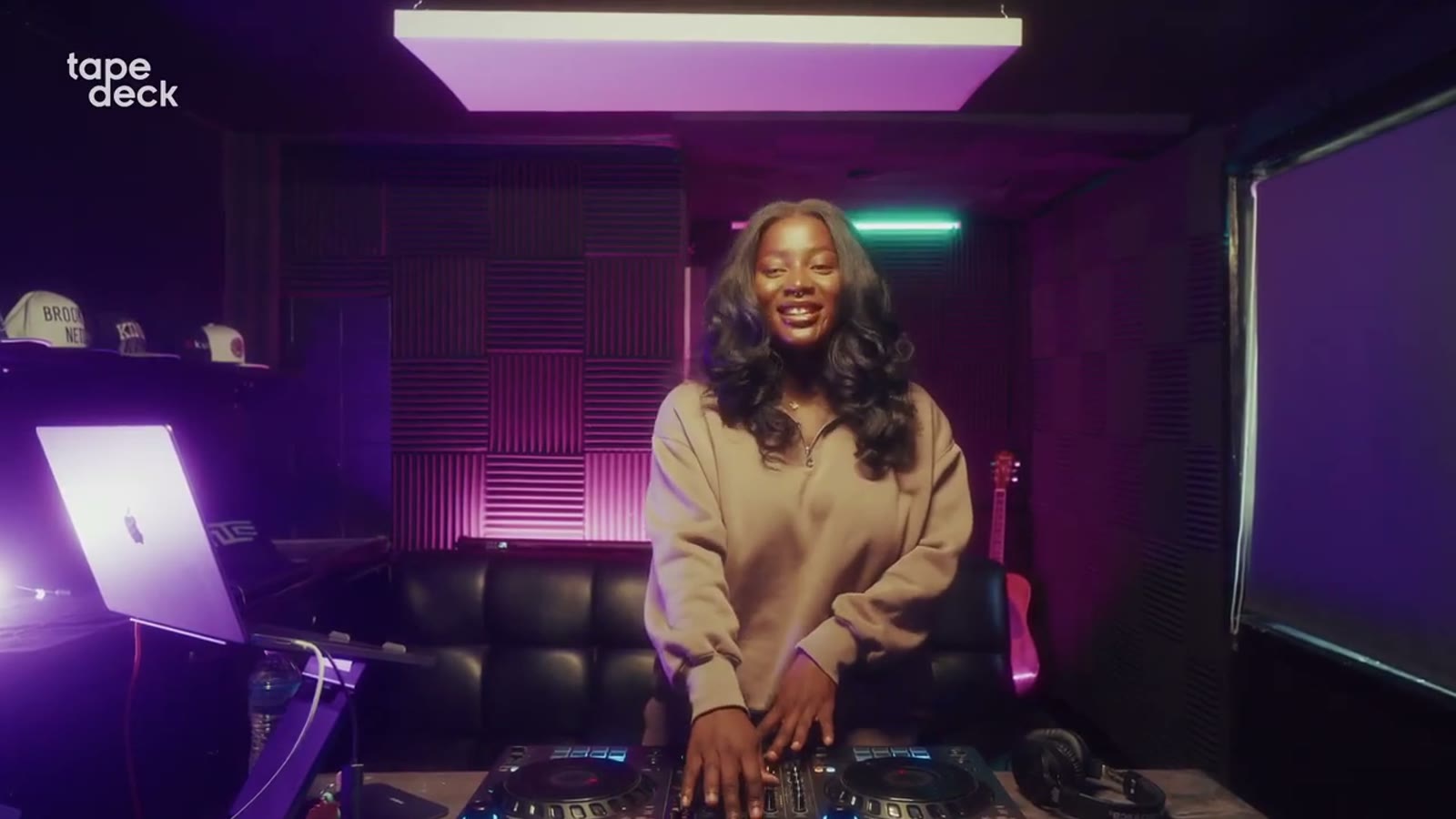 VTKAY performing an Amapiano set under warm neon light